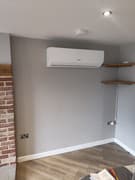 Technician servicing an air conditioning unit
